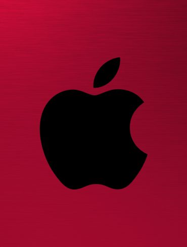 Apple AR VR Headset - Apple logo on a red, brushed metal background.